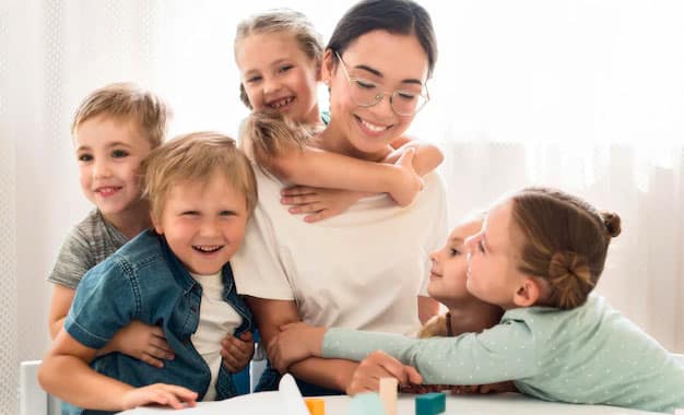 children-hugging-their-teacher children-hugging-their-teacher