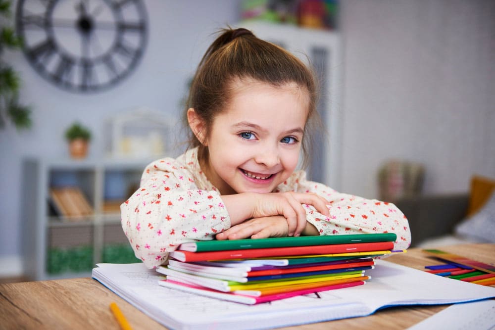 smiling-girl-studying-home